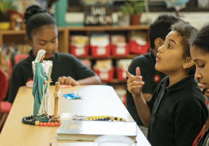 Children joyfully engaging with catechetical content.
